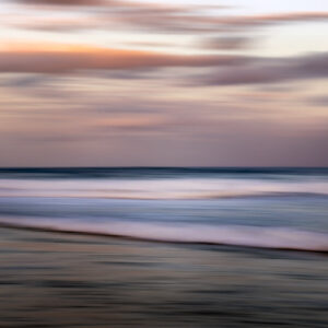 A photo of the ocean at dusk using long exposure to create a silky effect
