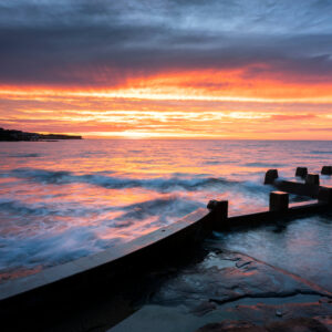 A photo of the sun rising over the Ross Mann pool in Coogee