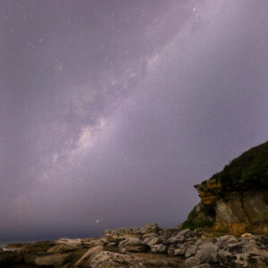 Milky way photographed over rocks at Little Bay in Sydney